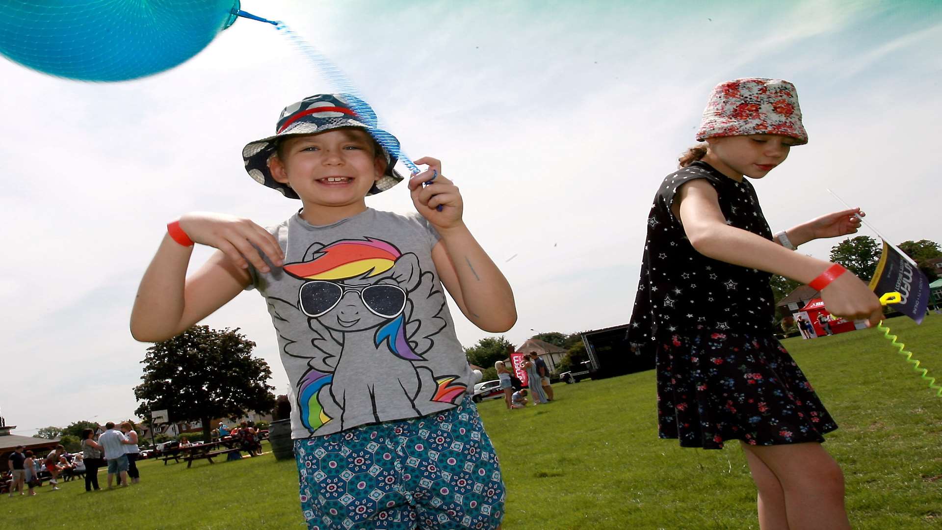 Amy (left) and Lucy (right) Bourne play with their balloons on springs.