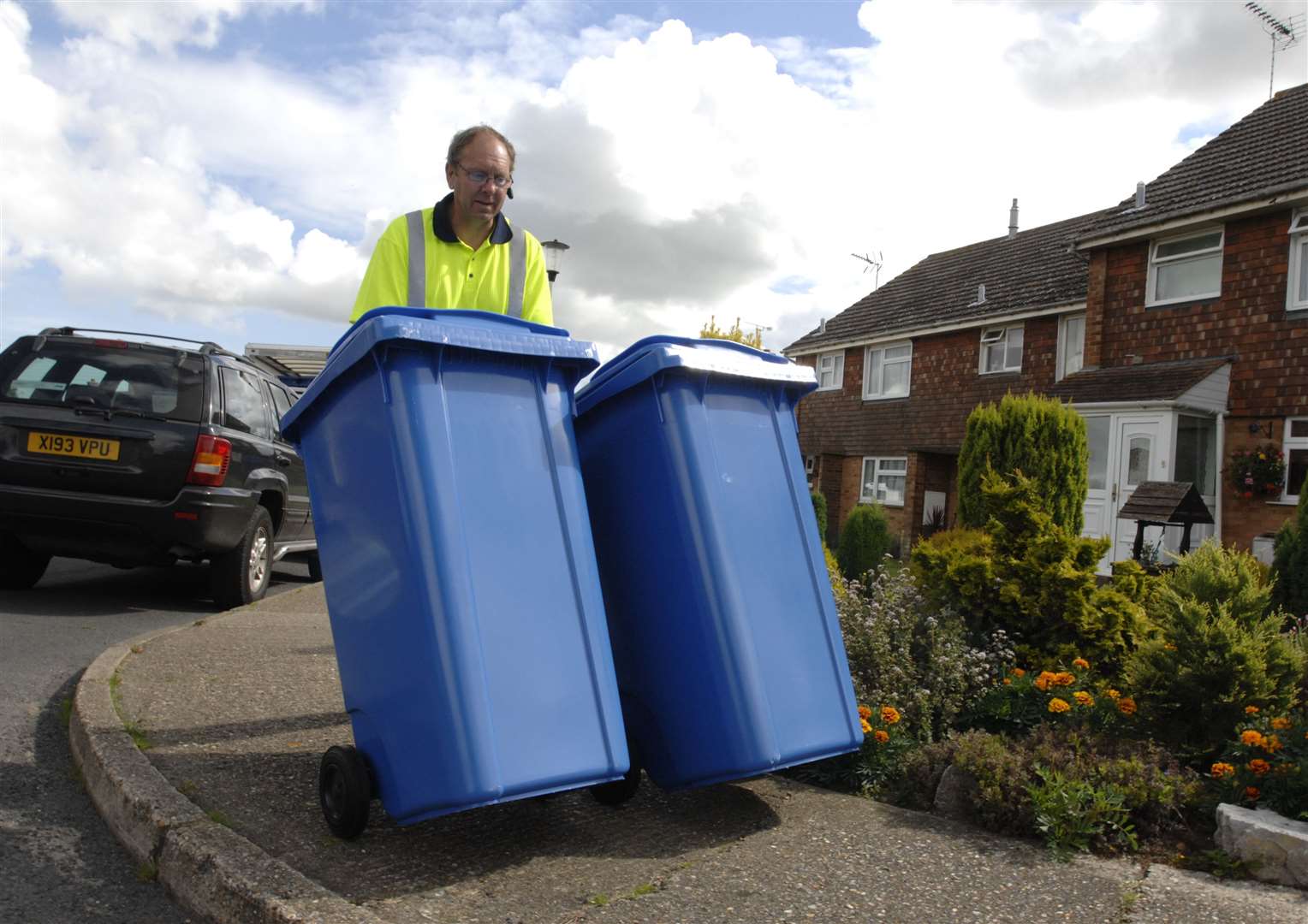 Mr Trevor Mills from Verdant busy delivering the new blue recycling bins in Boughton. Picture: Chris Davey