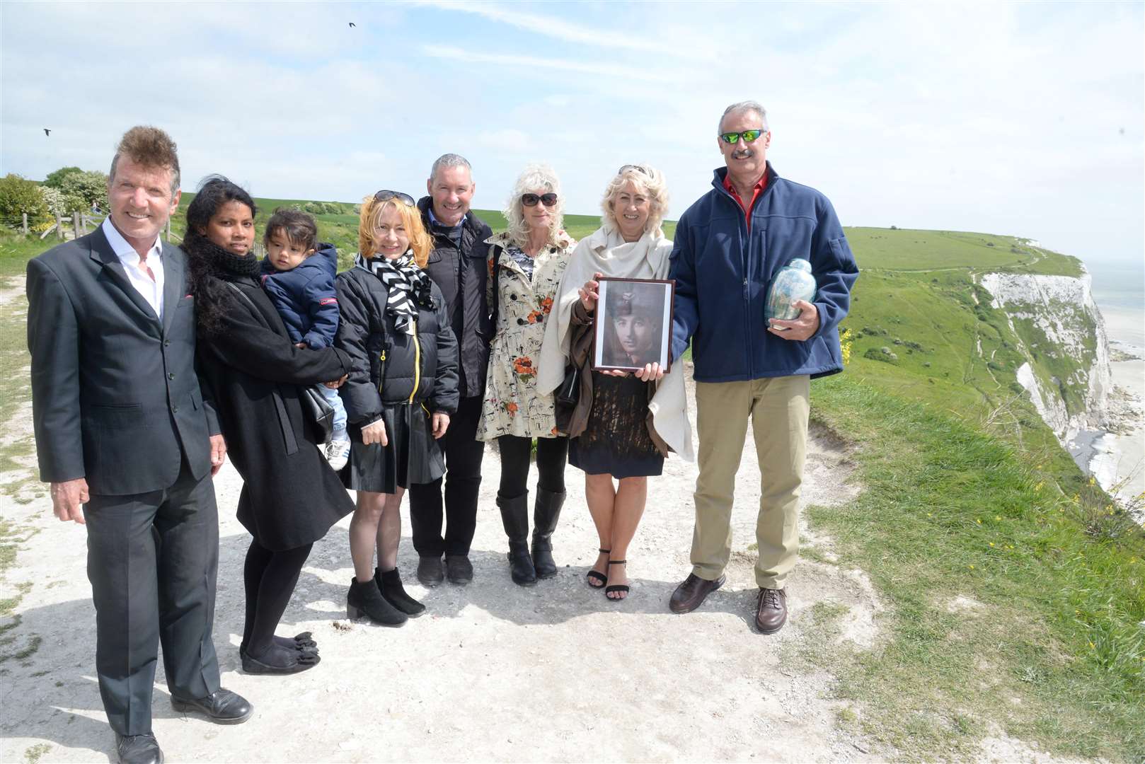 Paul Reynolds, nephew, Em and 18-month Alaric Reynolds, Nadya Meyers, Haydn Reynolds, nephew, Natalie Reynolds, neice, Gail Baylis, daughter and Craig Reynolds, son at the scattering of the ashes of Second World War airman Dermot Reynolds at Langdon Cliffs, Dover on Thursday. Picture: Chris Davey (2055835)