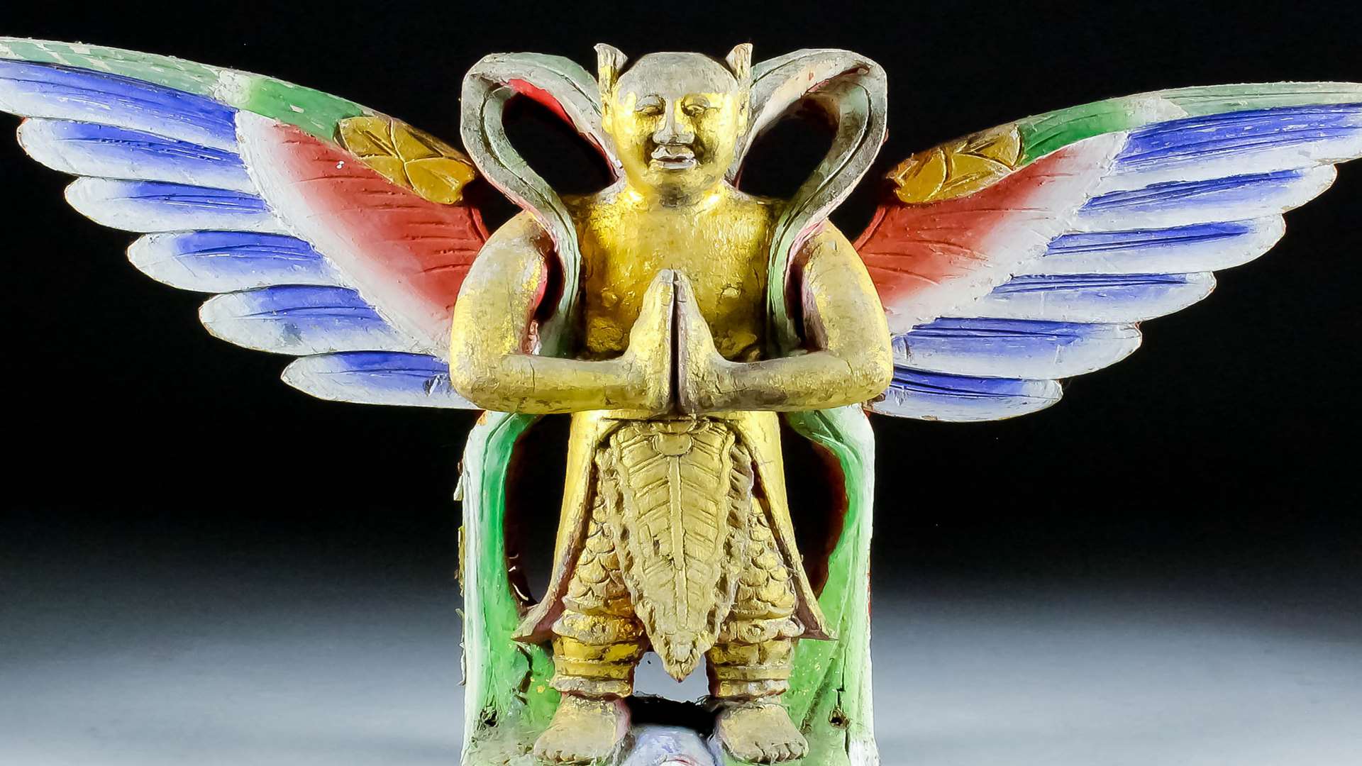 A Chinese carved polychrome and giltwood standing figure of an angel