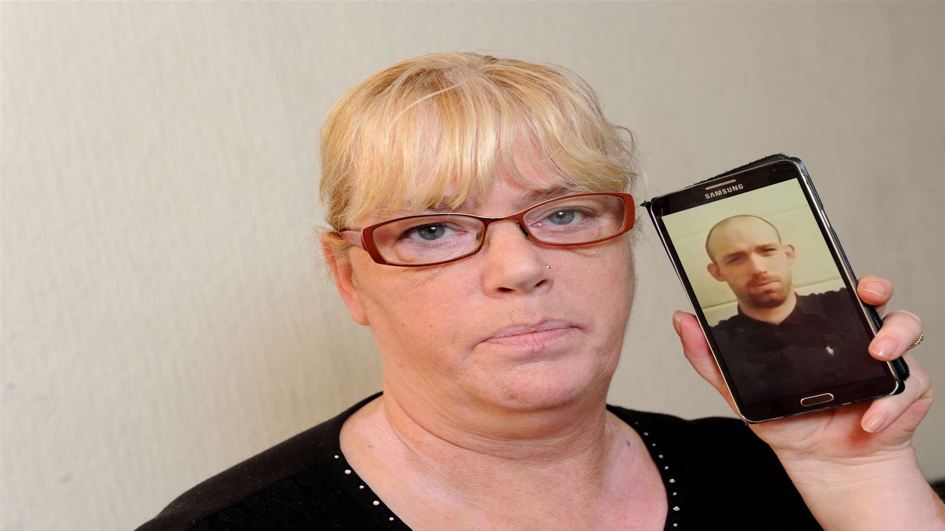 Carol Wilkins with a picture of her son Chris. Picture: Simon Hildrew