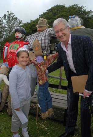 Comedian and TV presenter Paul O'Grady at the opening of Aldington school fete last year with competition winner Emily Phillips, seven