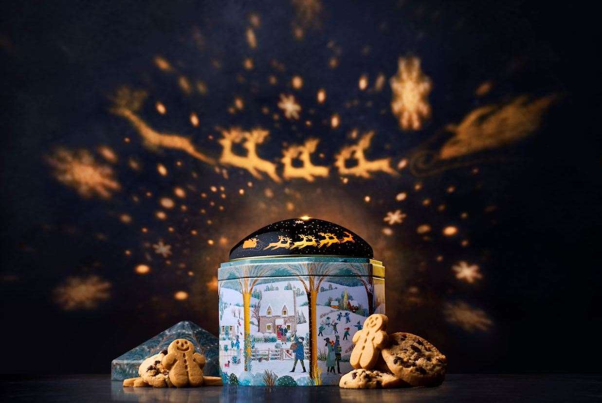 The Snowy Biscuit Tin projects a Christmas scene onto your ceiling