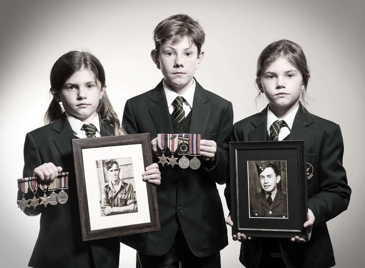 Edith, Alexander & May with pictures of their Great Grandfathers, Andrew Horne Thomson and Alexander Wishart. Picture: Scott Wishart