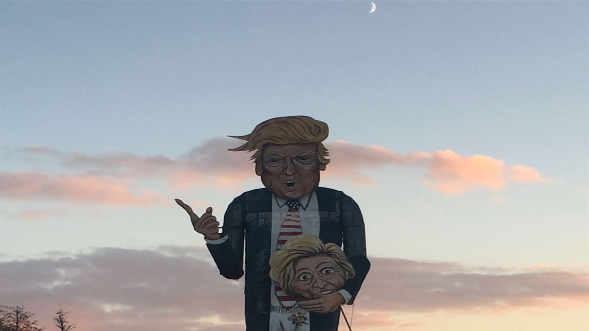 The Donald Trump figure waits for the torch