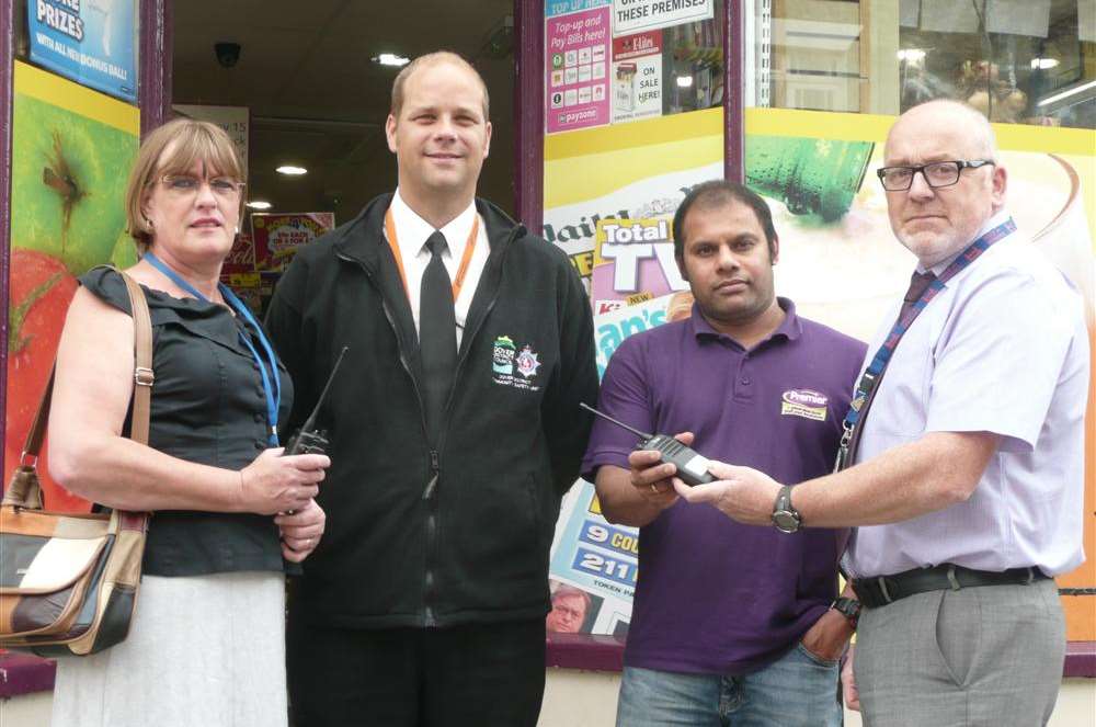 Niruban Naveenachandiran of Modern Moon in Castle Street receives the two-way radio from community safety officer Allan Rooke-James, with Karen Griffiths, co-ordinator of the Dover, Deal and Sandwich Partnership Against Crime, and PC Ian Belsey from the community safety unit.