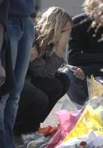 A devastated relative lays flowers at Romsey Close