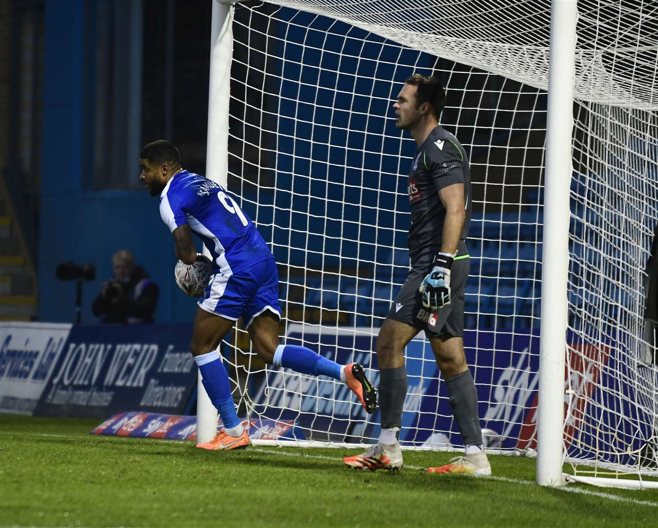 Dominic Samuel retrieves the ball after scoring Gillingham's equaliser against Woking in the FA Cup first round Picture: Barry Goodwin