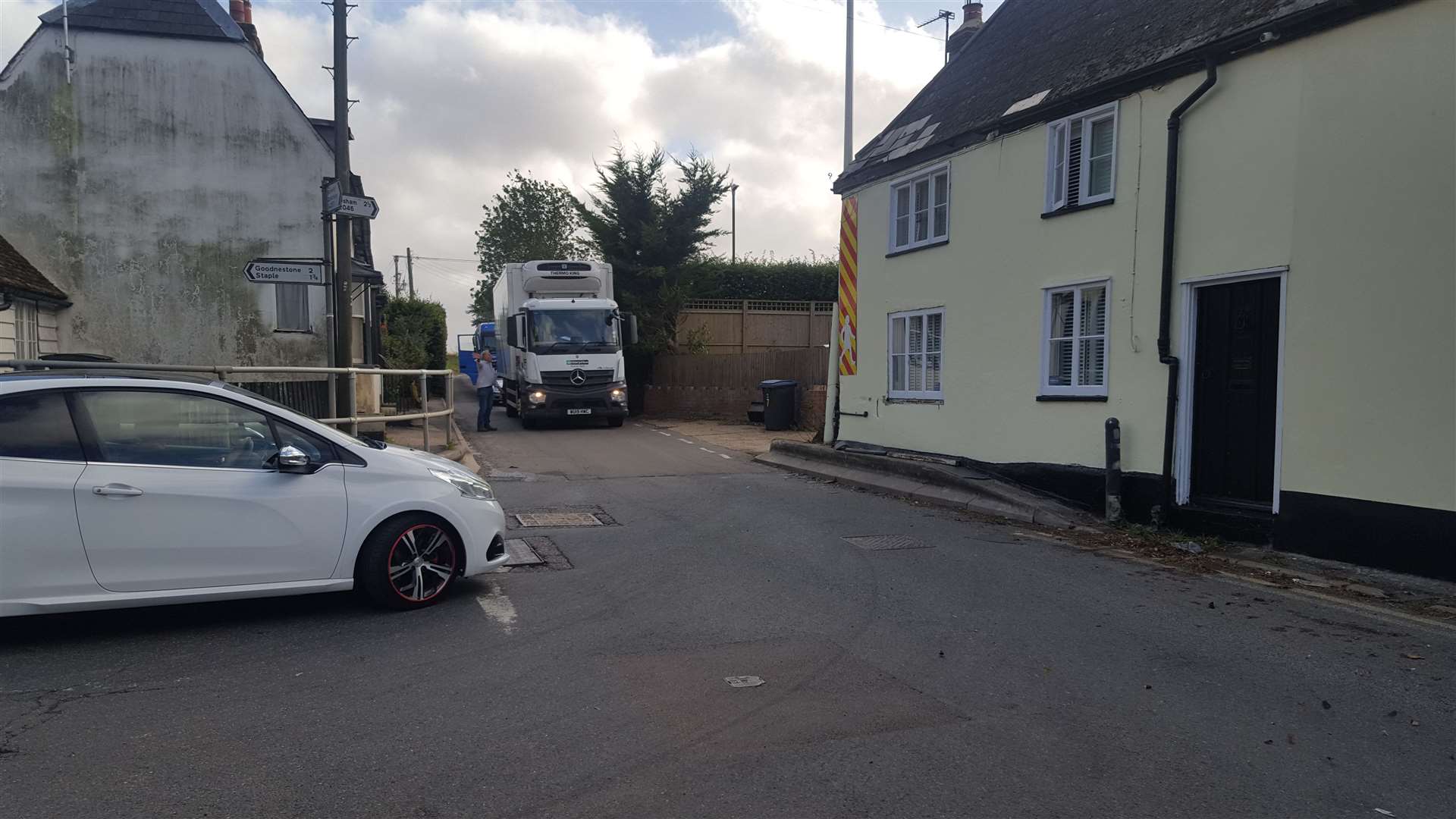 Heavy lorries struggle to negotiate the narrow road