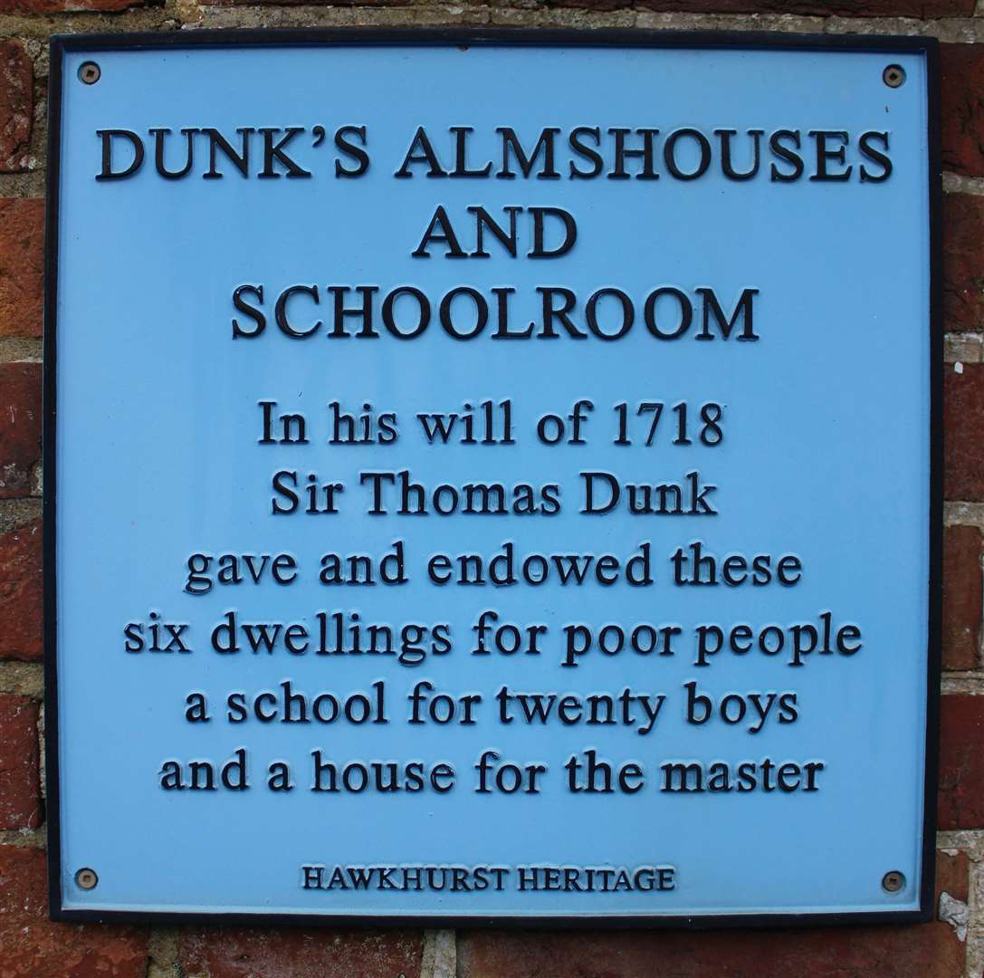 The Dunks plaque on the wall of the almshouses in Hawkhurst