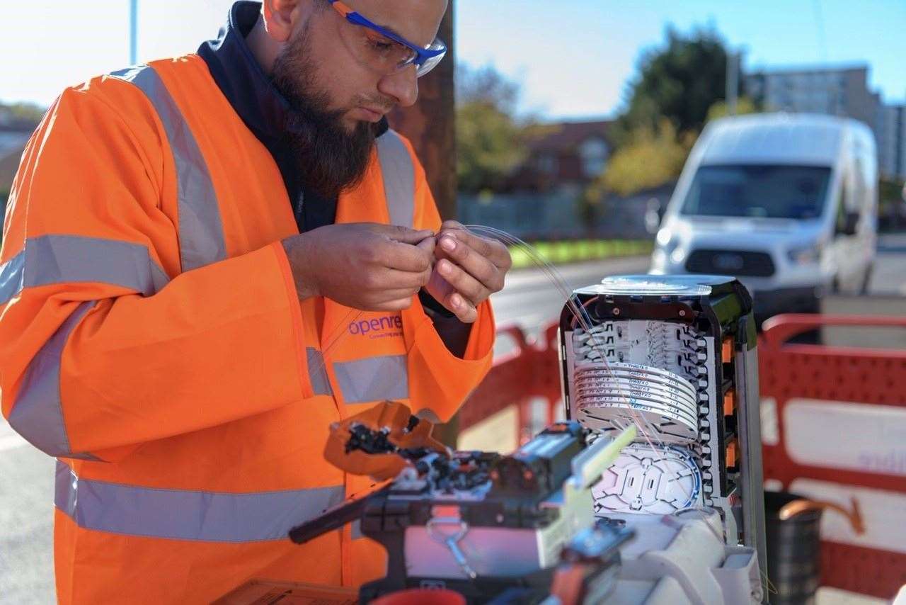 An Openreach engineer handling fibre cables. Stock picture