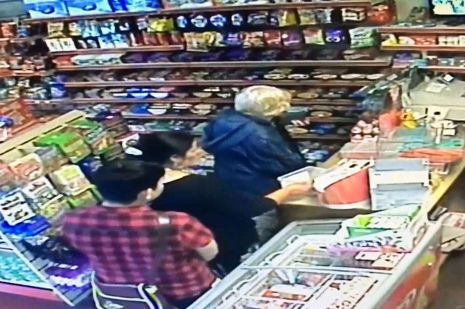 The pair enter the shop and the woman gets the staff member's attention