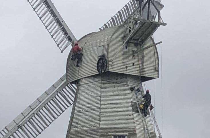 Workers repainting Willesborough windmill in Hythe Road. Picture: Ed Bell