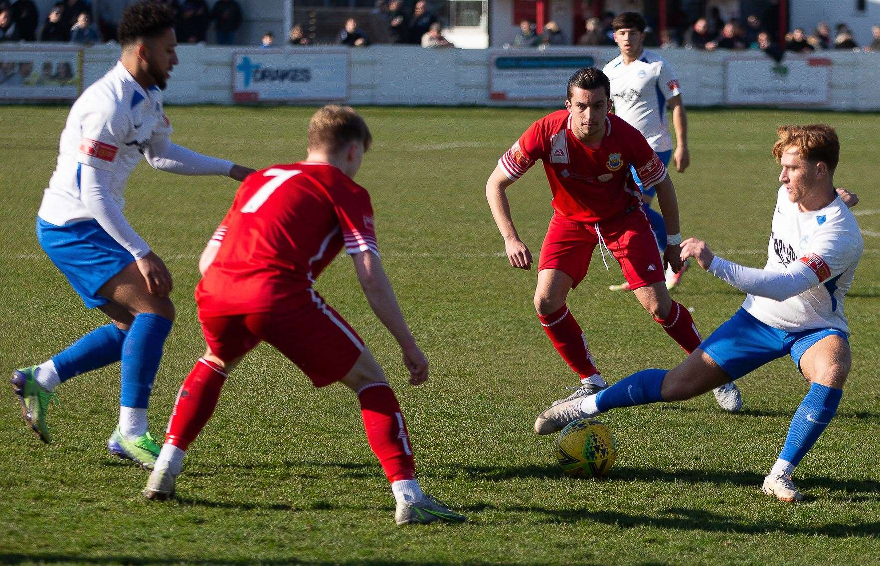 Whitstable duo George McIlroy and Will Thomas close in on a Hythe player. Picture: Les Biggs
