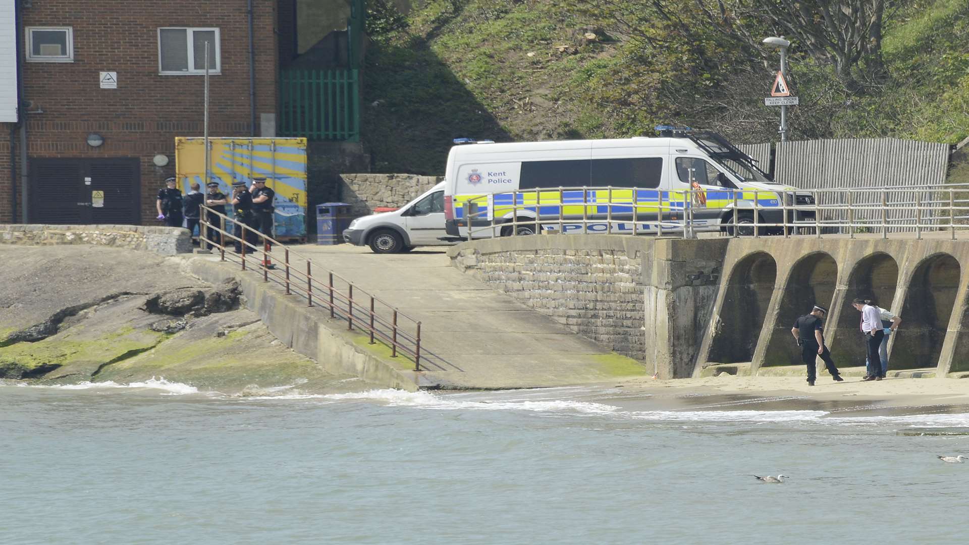 Police officers at the beach after Mr Kell's body was found