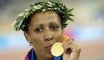 SWEET SUCCESS: Holmes with her coveted medal. Picture: PA