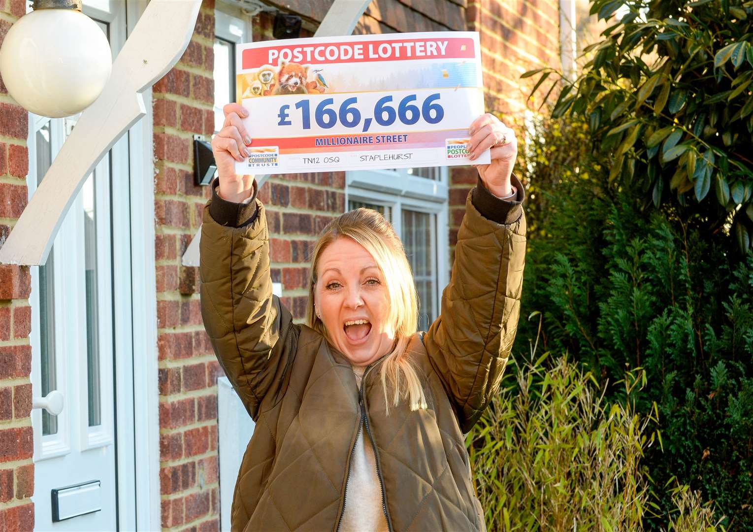 Kelly Southby, and her winning cheque. Picture: People's Postcode Lottery