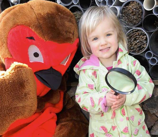 Ellie, 2, with the Robin mascot at the bug hotel.