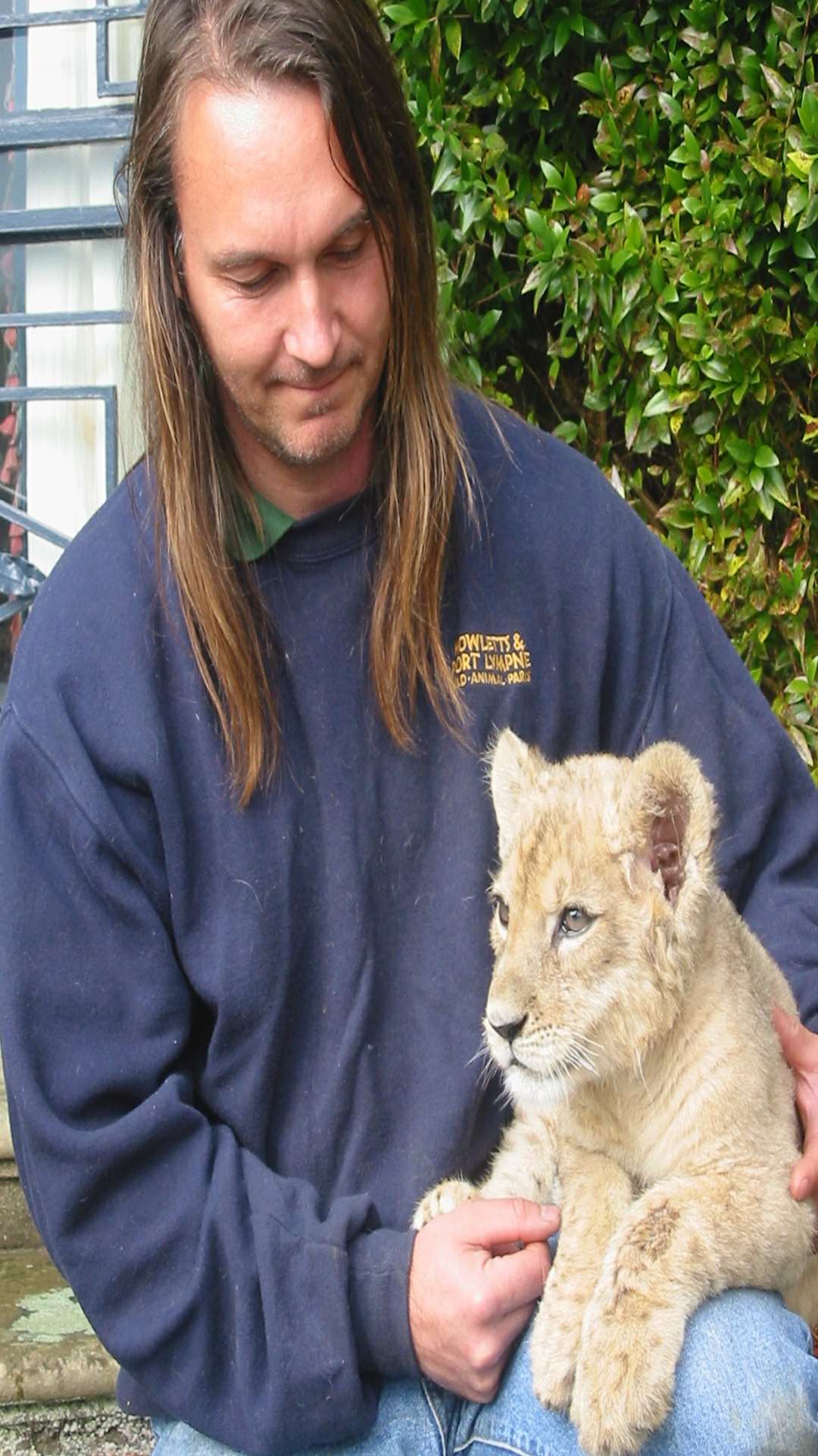 Samira as a cub with keeper Pete Thompson who hand reared her because of her injury