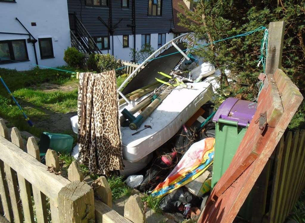 Three gardens in Folkestone with piles of rubbish stacked up has left the residents with huge fines