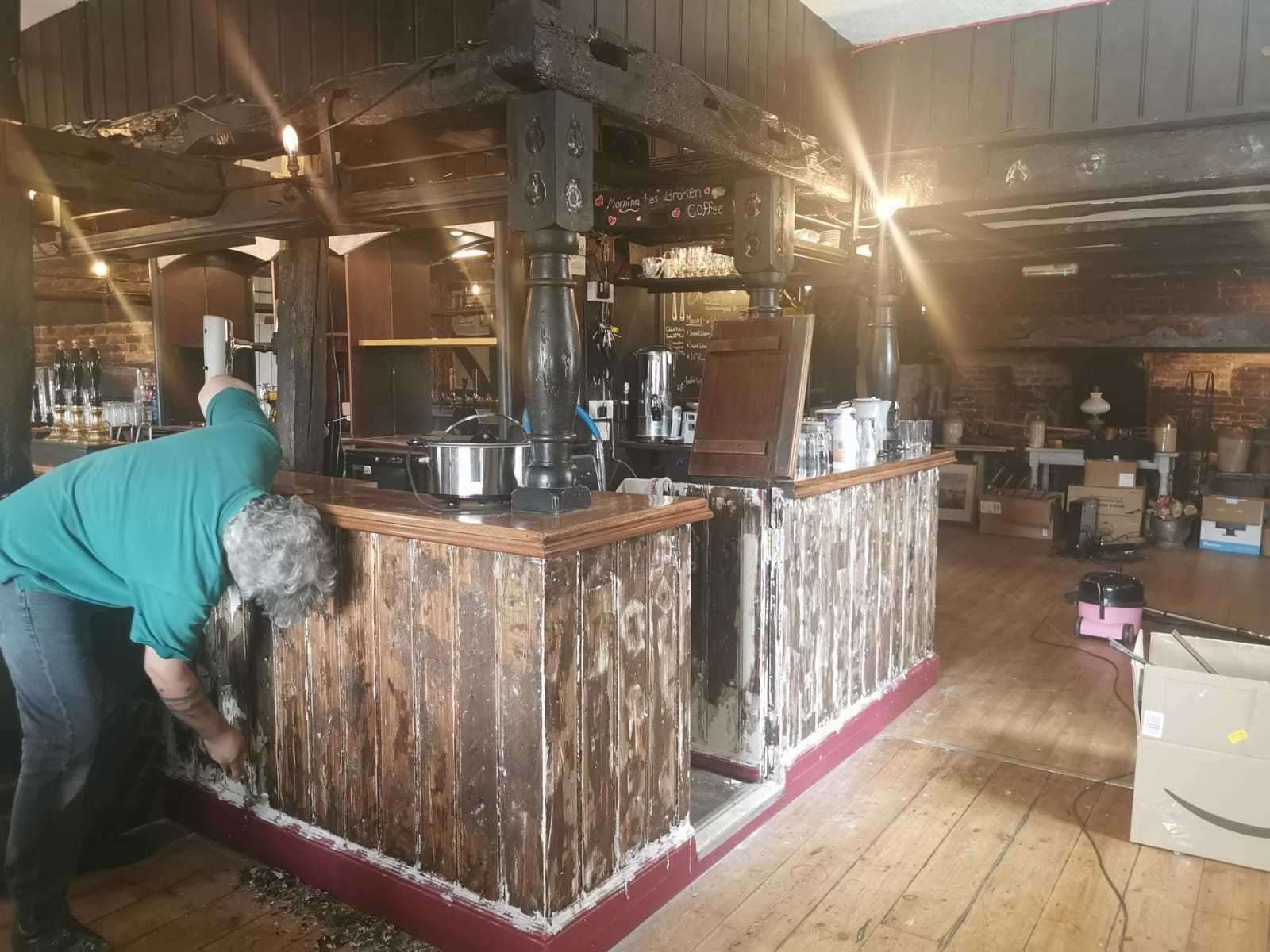 Lee working to restore the bar during the refurbishment
