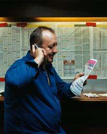 A man on the phone in a betting shop