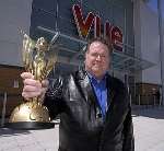 Carl Tooney outside the Vue Cinema with a Best Picture statue.