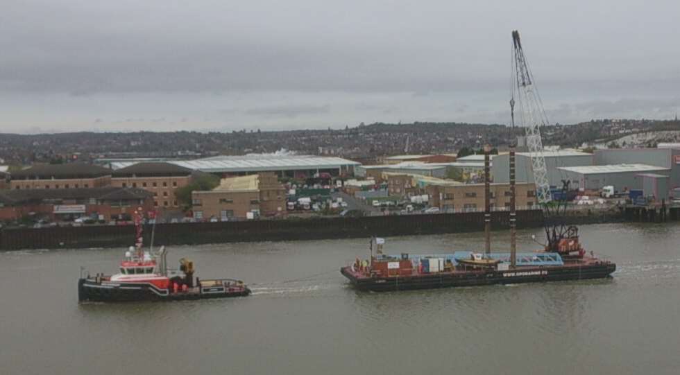 A crane is towed down the Medway to start work at Sun Pier