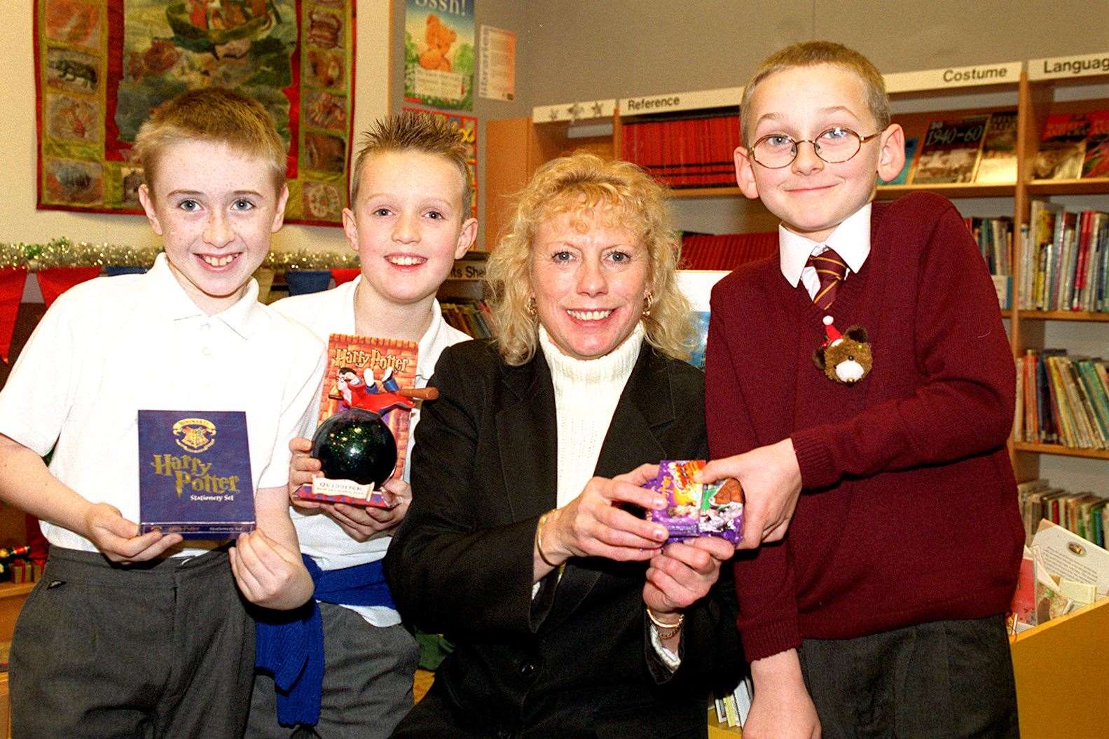 Harry Potter competition winners at Sheerness library - cinema manager presenting prizes to James Squillaci, Rose Fosbraey and Kerr Jeferies