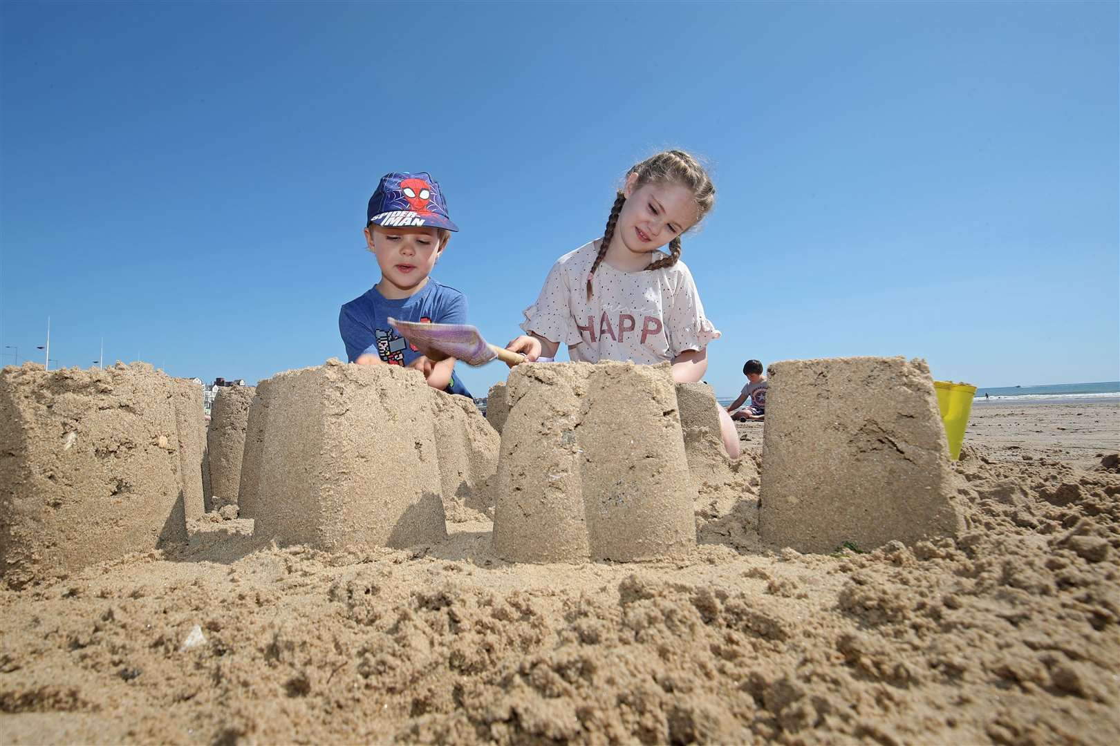 Zachary Bower, four, and Isabelle Bower, eight, enjoy making sandcastles on Bridlington beach in East Yorkshire (Danny Lawson/PA)