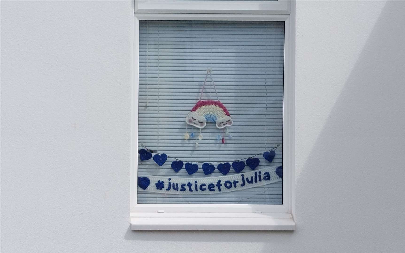 A crocheted 'justice for Julia' sign remains hung in a window in Snowdown