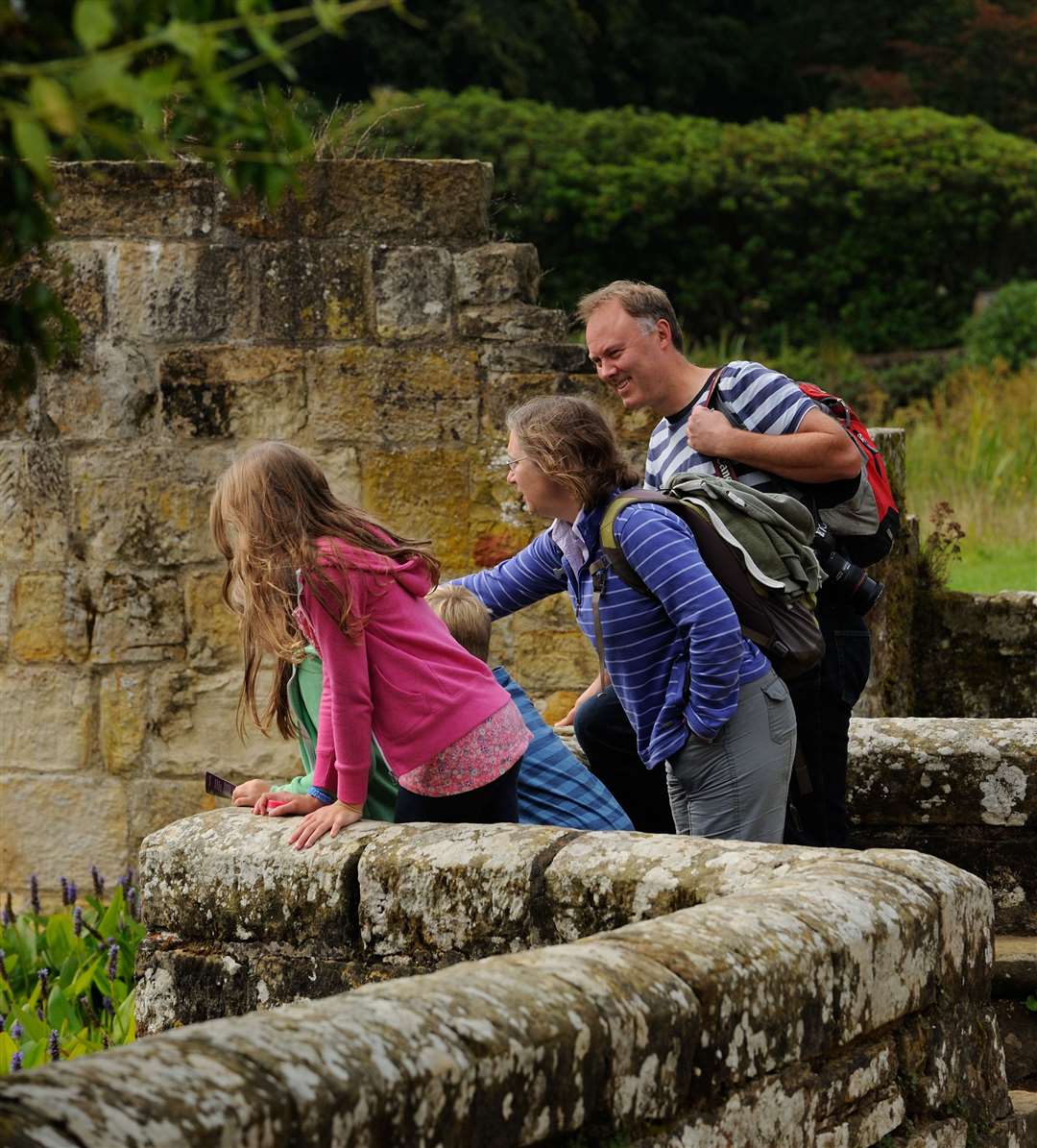 A family in the gardens at Scotney Castle. Picture: John MIllar/National Trust