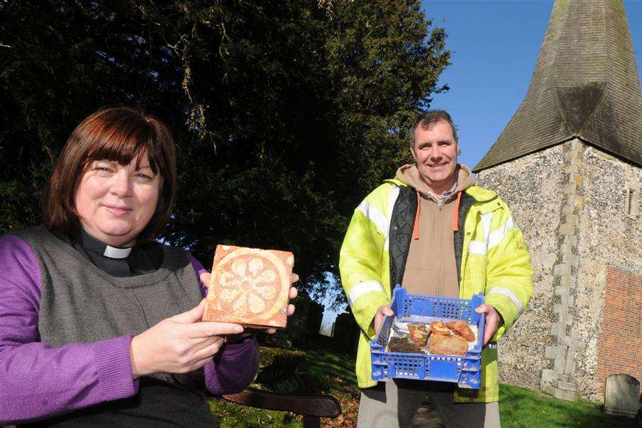 Andy Linklater, of Canterbury Archaeological Trust, and Rev Lesley Jones pictured holding samples of floor tiles.