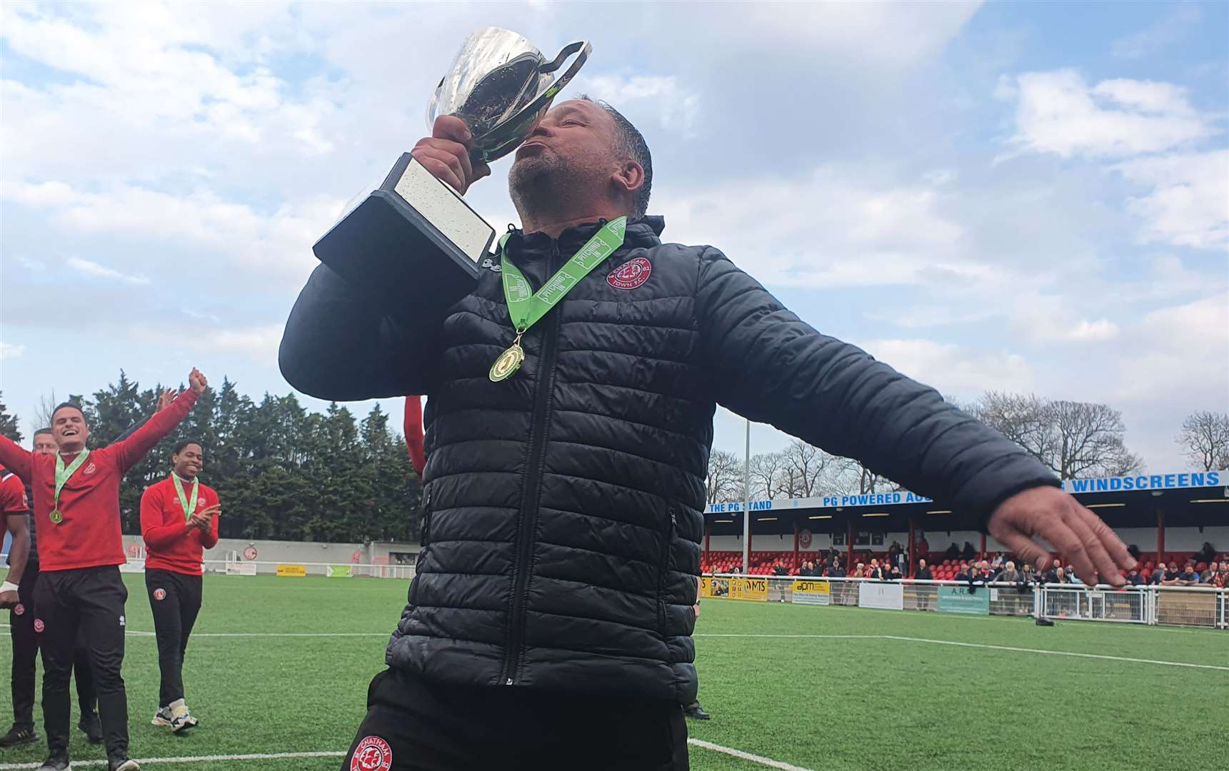 Chatham boss Kevin Hake kisses the Isthmian South East trophy