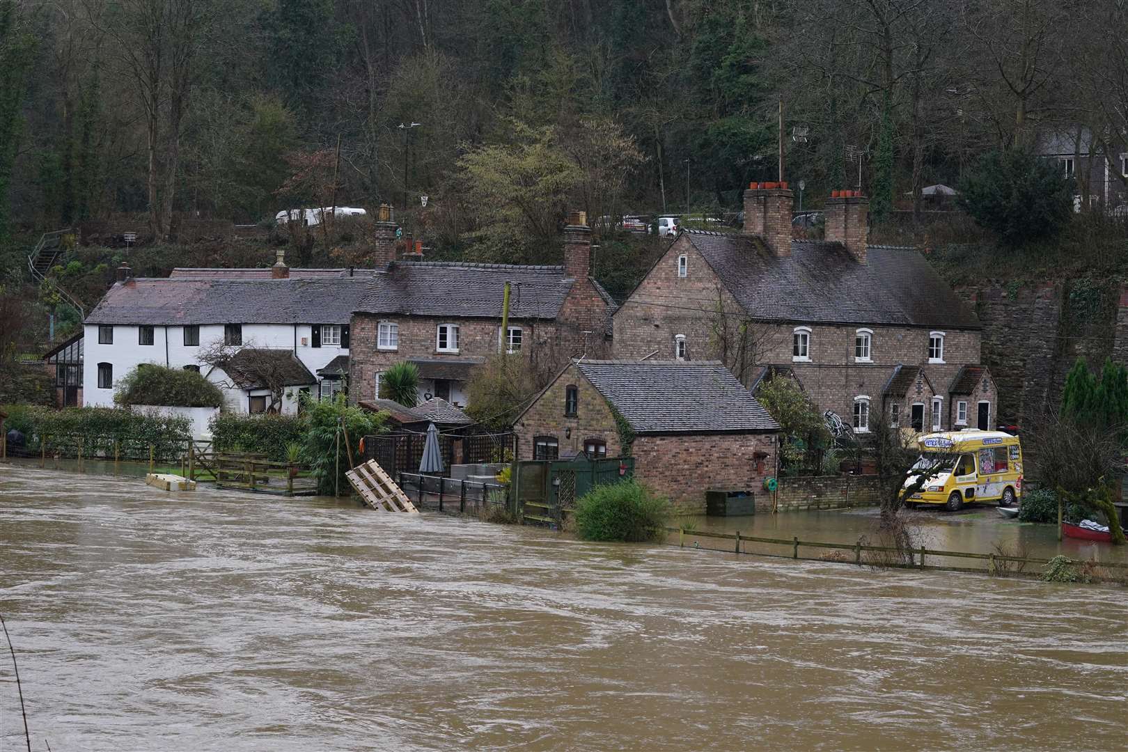 The waters of the River Severn in edge towards homes in Ironbridge, Shropshire (Nick Potts/PA)