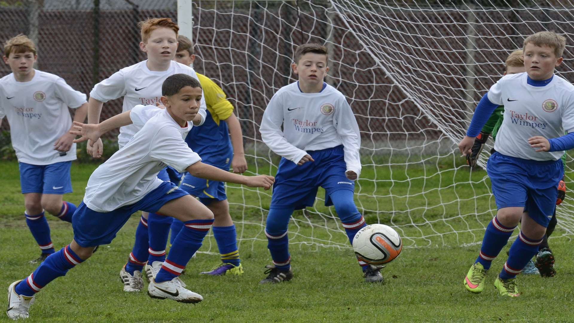 Woodpecker HI (white) chase a loose ball against Strood 87 Rangers in Under-13 Division 1. Picture: Chris Davey