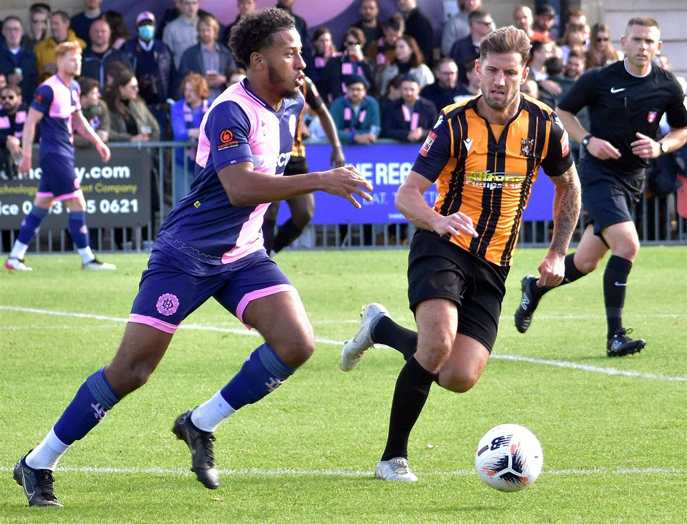 Folkestone's James Rogers, right, gives chase against Dulwich Hamlet. Picture: Randolph File