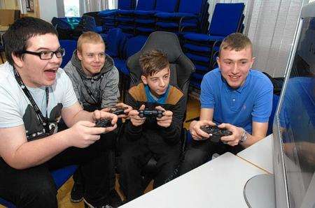 Terry Wells, Jack Bonner, Ben Simmonds and Shaun Clark play one of the electronic football games