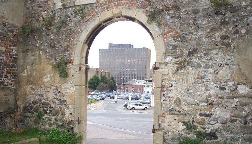 The area due for redevelopment, framed by the archway of the ruins of St James' Church.