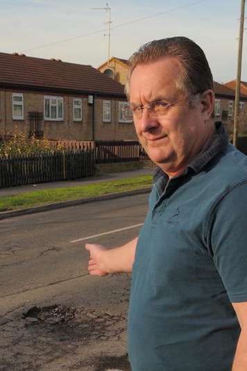 John Freeman shows the pothole before Kent Highways' temporary patch up last week