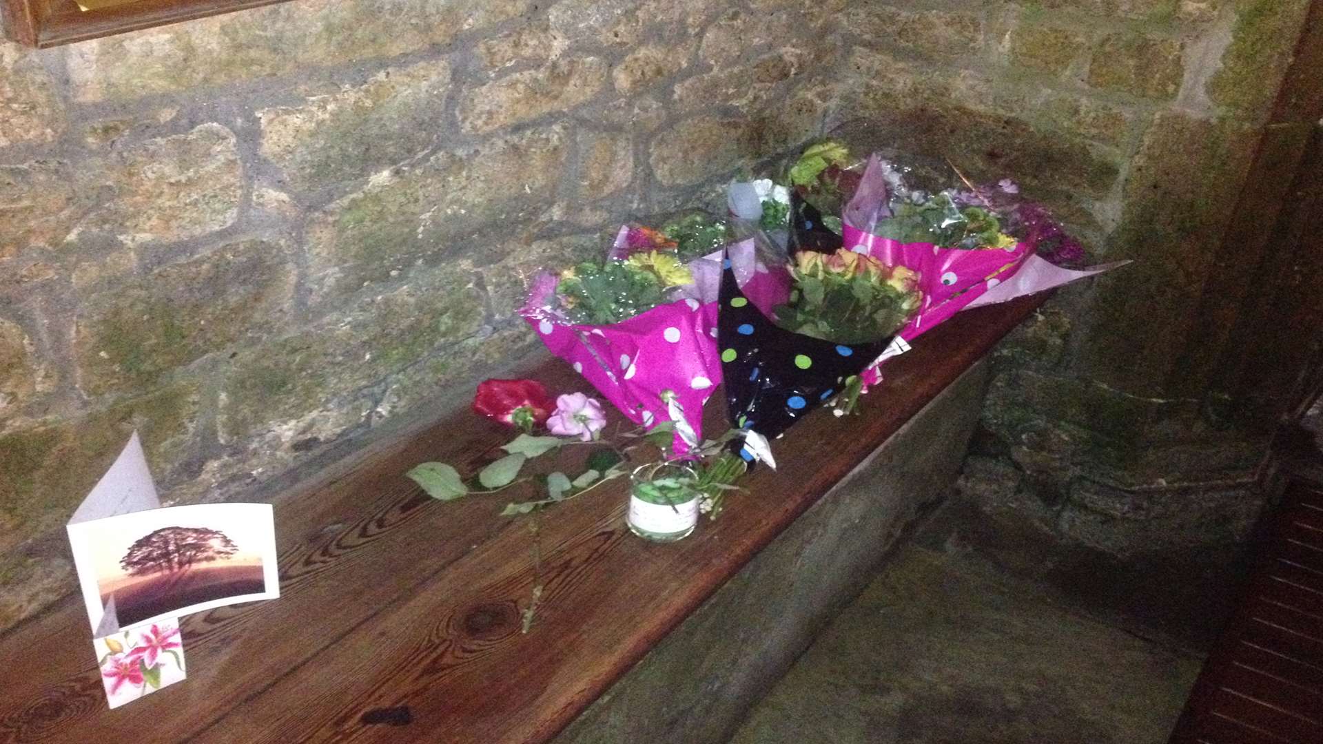 Flowers laid in the porch of the church where Mr Hillman's body was found