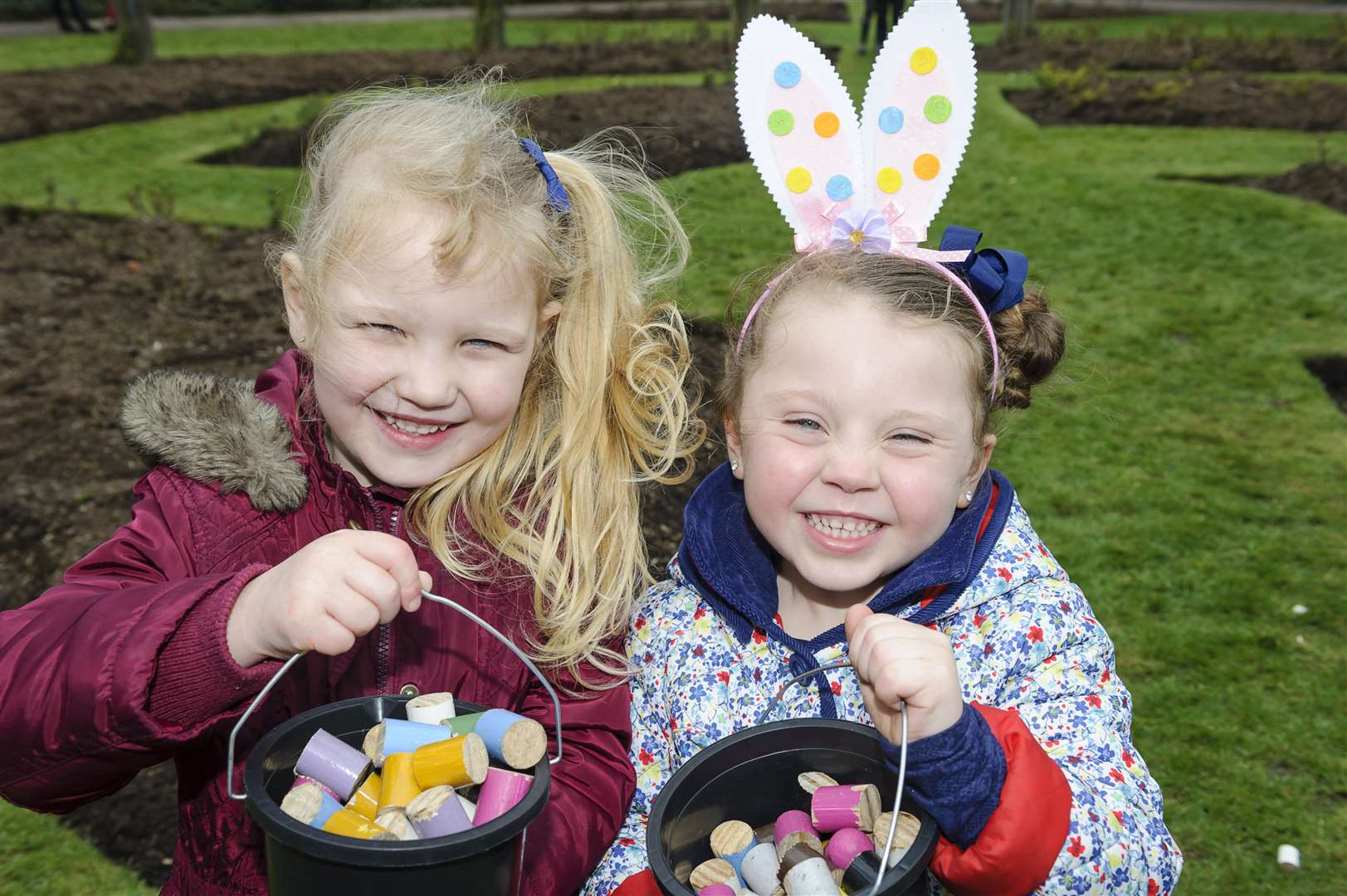 Lilly, 4, and Grace, 4, enjoy an Easter egg hunt organised by Dartford Round Table, at Central Park, Dartford.