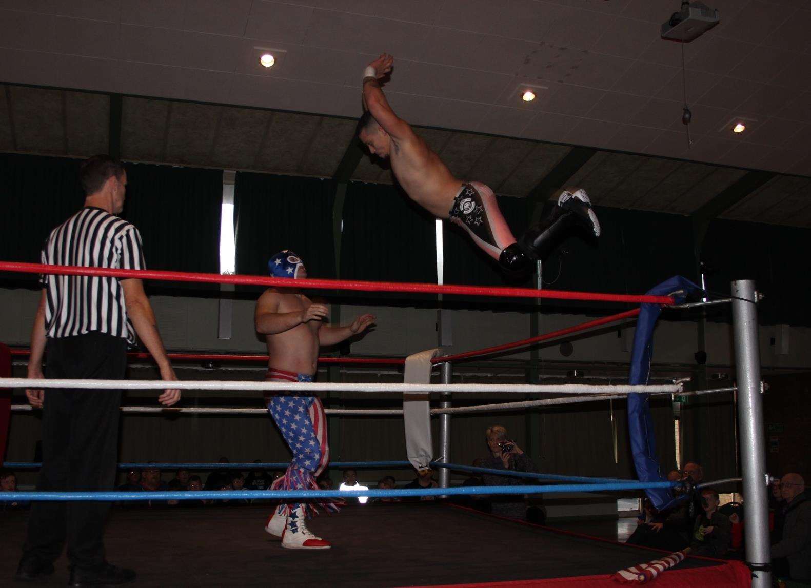 Dazzler Darrell Allen launches himself from a post onto Mr USA in the quarter-final at Rumble Wrestling's championship bout at Kemsley village hall (6296666)