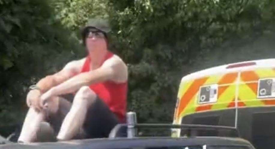 More than 65,000 people have seen the video of a man sitting on top his car and blocking a speed camera van in Willington Street, Maidstone. Picture: @maidstone_roofer