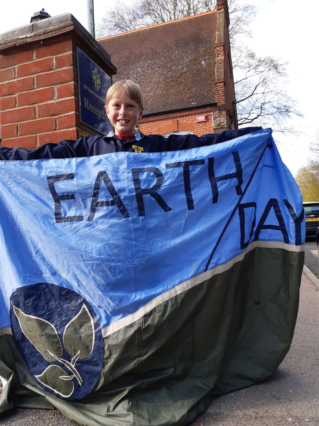 Year 7 year pupil Joshua designed Sir Roger Manwood's School's Earth Day flag as the school comes out in support of the environment