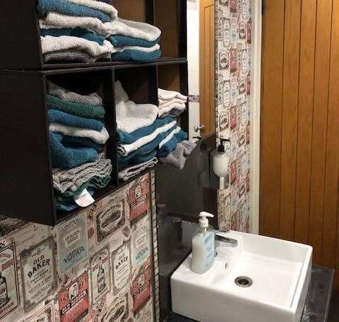 The neatly wallpapered wall in the gents has a wall cabinet with freshly laundered individual flannels to dry your hands, a nice personal touch.