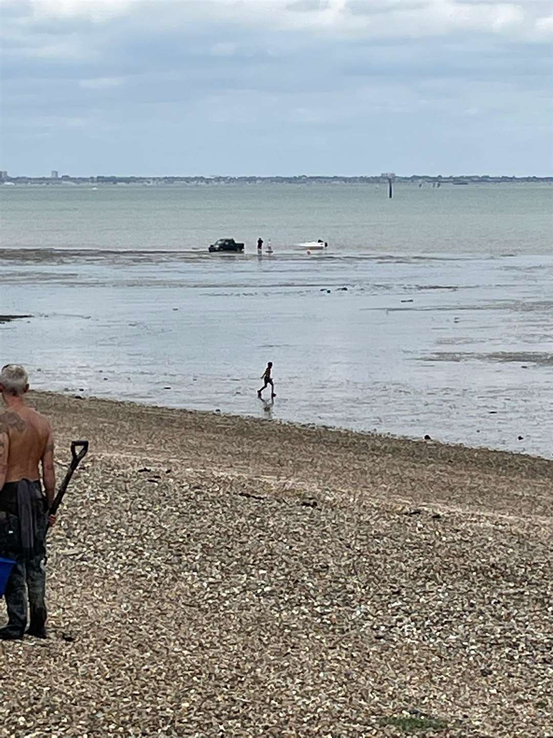 A car has become stuck in the sea in Minster. Photo: Martin Nelson