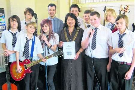 Lord Mayor Cllr Carolyn Parry and music teacher Richard Naylor with pupils from Spires Academy's Rock Band project