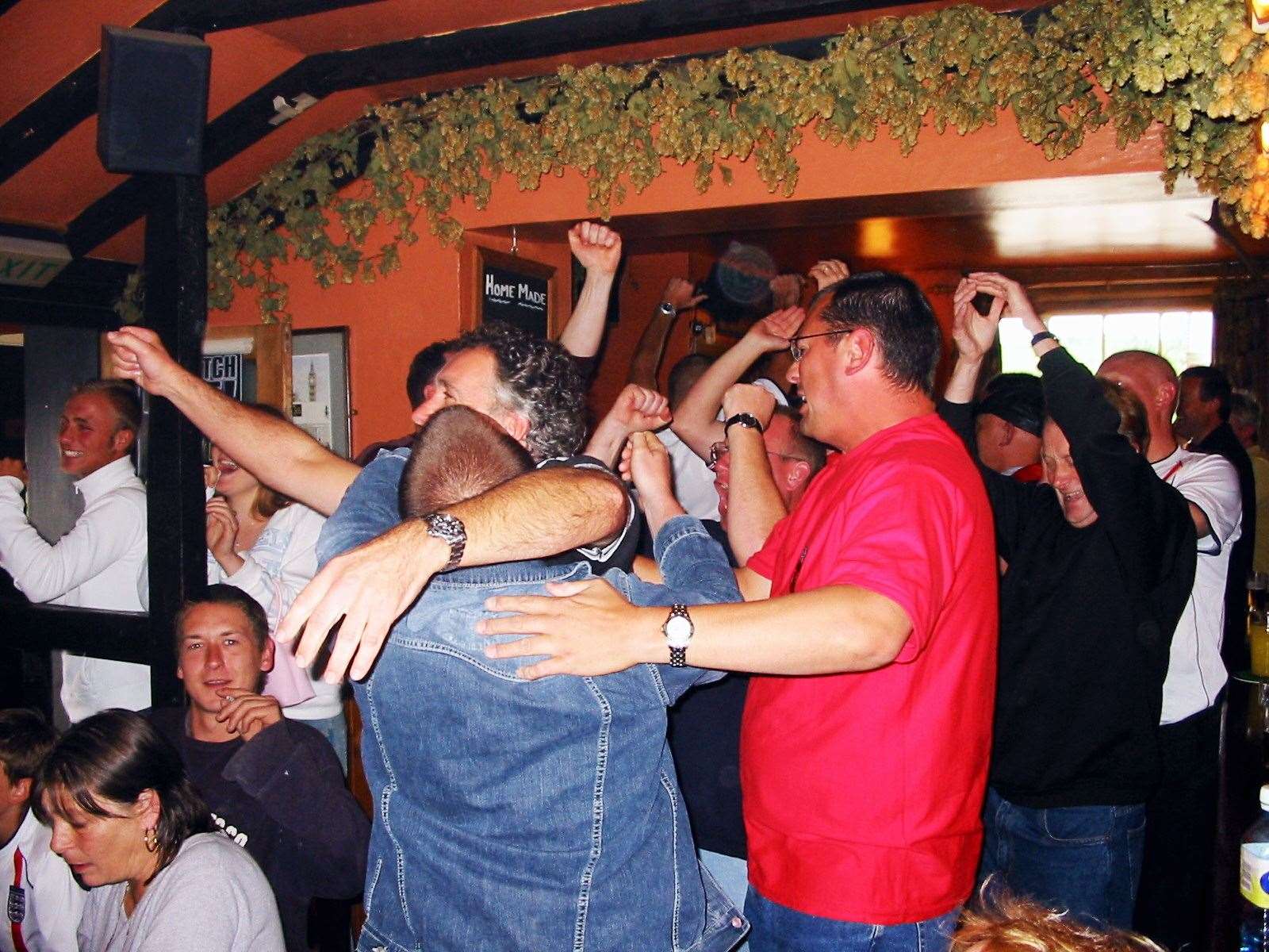 Football fans at the Ship Inn, Ospringe, celebrate after England beat Argentina in the 2002 World Cup