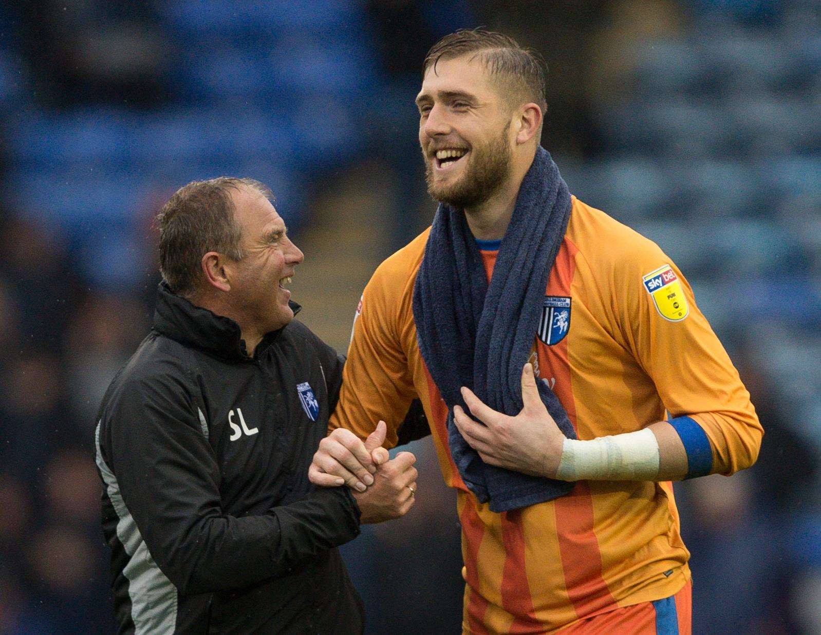 Gills boss Steve Lovell toasts victory at the final whistle with keeper Tomas Holy Picture: Ady Kerry